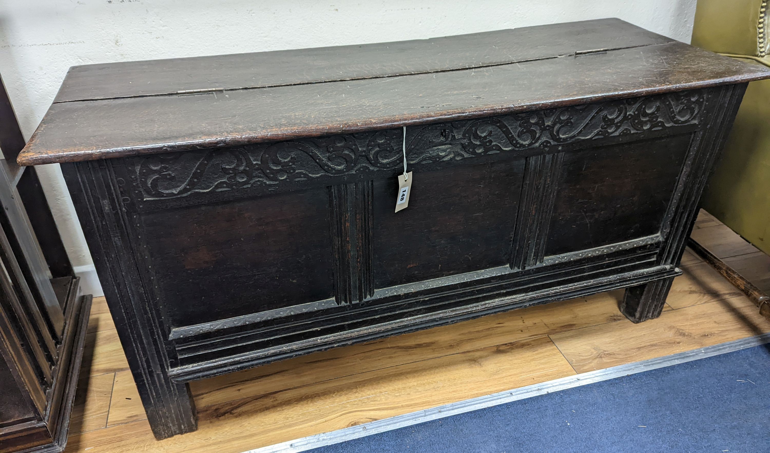 A 17th century panelled oak coffer, (the hinged lid adapted) width 130cm, depth 49cm, height 63cm